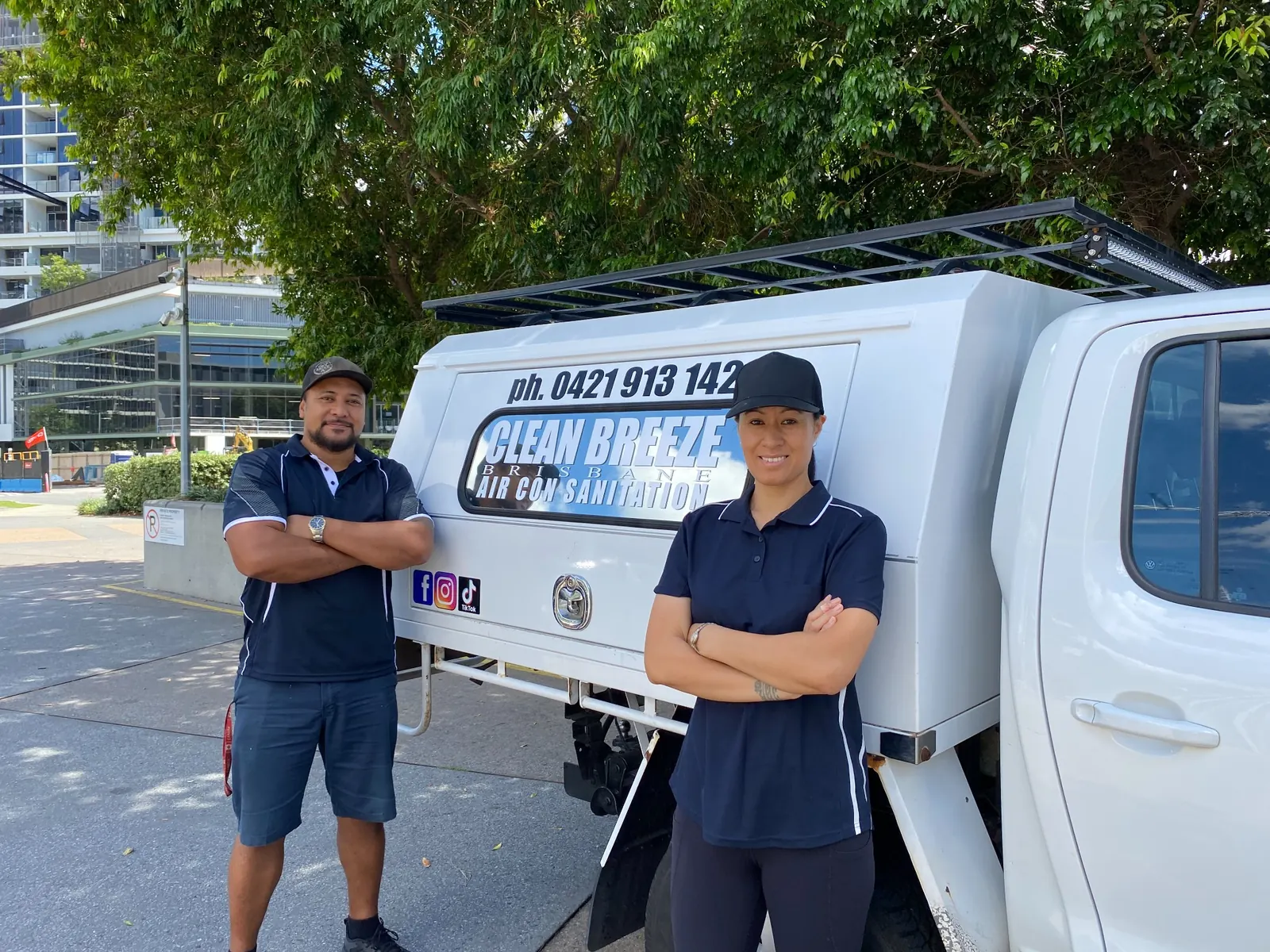 Clean Breeze Brisbane team beside their service vehicle