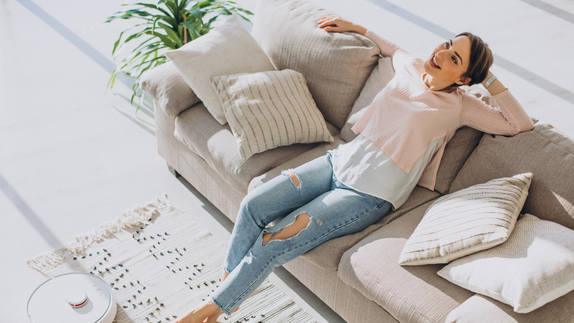 Woman Relaxing Sofa While Robot Vacuum Cleaner Doing Housework 1